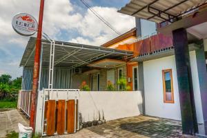 a house under construction with a fence in front of it at Omah Leren Mitra RedDoorz near Gembiraloka Zoo Yogyakarta in Timuran