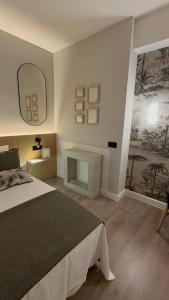 Postel nebo postele na pokoji v ubytování APARTAMENTOS ALCALA