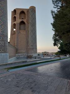 a large building with a tower in the background at Family guest house SEVEN in Samarkand