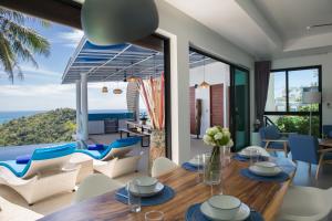 a dining room with a view of the ocean at Villa La Moon Chaweng Noi 4BR in Koh Samui 