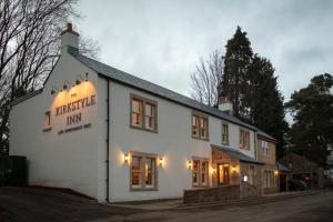 a white building with a sign that reads fantastic inn at The Kirkstyle Inn & Sportsman Rest in Brampton