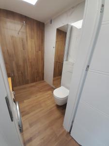 a small bathroom with a toilet and a shower at Apartament Leszczynki in Gdynia +12 photos