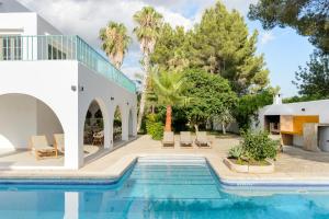 a swimming pool in the backyard of a house at Villa Maria - Luxury Getaway in Ses Paisses