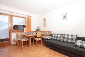 a living room with a couch and a table at Oberhuberhof in Rodengo