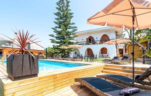 a pool with chairs and umbrellas next to a house at MaryWilliam in Agropoli
