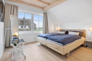 Ένα ή περισσότερα κρεβάτια σε δωμάτιο στο Ferienhaus Wave