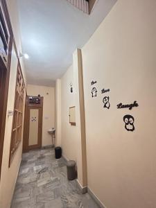 a hallway with a wall with stickers on it at Namaste Amritsar Homestay in Amritsar