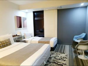 Ένα ή περισσότερα κρεβάτια σε δωμάτιο στο JS Boutique Hotel