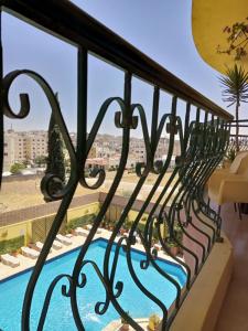 a balcony with a view of a swimming pool at Mariam Hotel in Madaba