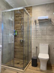a shower stall in a bathroom with a toilet at AMMOS Beach apartment in Sidari