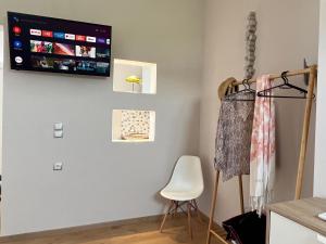 a living room with a tv on the wall at AMMOS Beach apartment in Sidari
