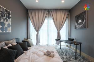 a bedroom with a bed and a desk with a laptop at Private Studio in Bungalow by LilyandLoft in Subang Jaya
