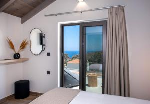 a bedroom with a view of the ocean at Armour Eclectic Villa in Afráta