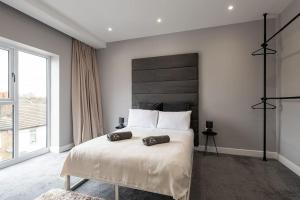 a bedroom with a large bed and a large window at Luxury Apartments in Gillingham in Gillingham