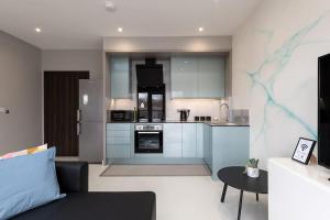 a kitchen with a couch and a table in a room at Luxury Apartments in Gillingham in Gillingham