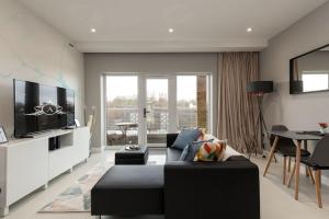 a living room with a couch and a tv at Luxury Apartments in Gillingham in Gillingham