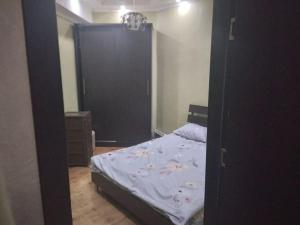 a bedroom with a bed and a large door at One bedroom apartment for rent in Tbilisi City