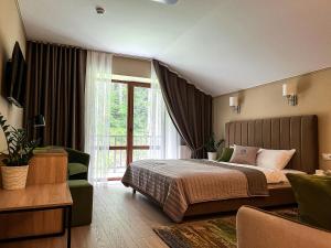 a bedroom with a bed and a large window at Blueberryhouse in Bukovel