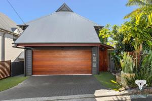 a garage with a wooden door in a house at KozyGuru | Spring Hill | Cosy 1 Bed1Bath in Brisbane +9 photos