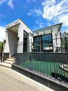 a building with a fence in front of it at Hotel Ticiani 13 in Kutaisi