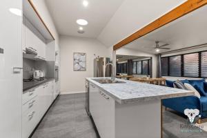 a kitchen and living room with a couch and a counter at KozyGuru | Spring Hill | 2 Bed 2.5 Bath in Brisbane