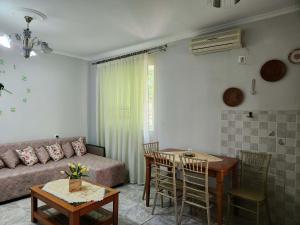 a living room with a couch and a table at Cosy guest house in Sarandë