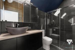 a bathroom with a sink and a toilet at KozyGuru | Spring Hill | 2 Bed 2.5 Bath in Brisbane