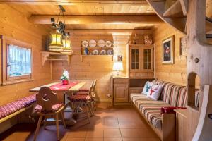 a kitchen with a couch and a table in a room at Baita Pecol Passo Pordoi in Canazei