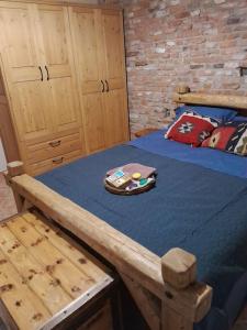 a bedroom with a wooden bed with a blue comforter at Villa Nestor in Platamonas