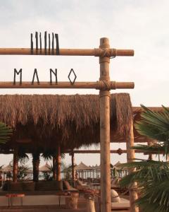 a sign that says man in front of a resort at Hotel Athina in Velipojë