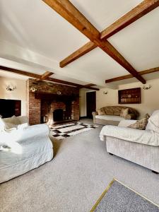 a living room with two beds and a fireplace at Ground floor apartment in The Coach House in Hartford
