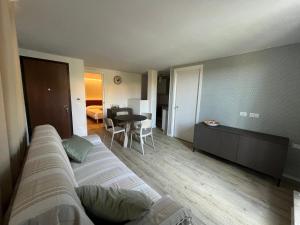 a living room with a bed and a dining room at La casa del Gallo in Pietra Ligure