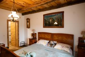 a bedroom with a bed and a painting on the wall at KONAK in Pleternica