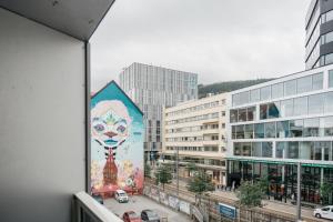 a mural on the side of a building in a city at Nordic Nights: 3BR with Balcony in Bergen