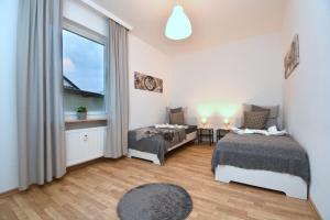 1 Schlafzimmer mit 2 Betten und einem Fenster in der Unterkunft ERH01-RI Flat in Herzogenaurach in Herzogenaurach