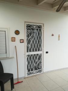 a door with a wrought iron gate in a room at Sal y Mar in Torre San Giovanni Ugento