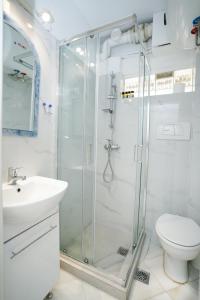 a bathroom with a shower and a toilet and a sink at Endless Blue Studio in Glyfada in Athens