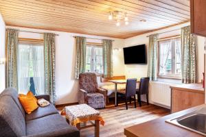 a living room with a couch and a table at Ferienwohnung - Hexi in Bad Kohlgrub