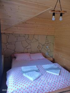 a bedroom with a bed with two towels on it at ART House Transylvania , Valea Avrigului , Sibiu in Avrig