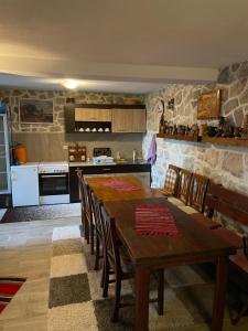 a kitchen with a wooden table and chairs in a room at Top of the hill - Paradise in Ulcinj