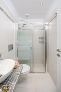 a bathroom with a shower and a toilet and a sink at Victoria Studios & Apartments in Mikri Vigla