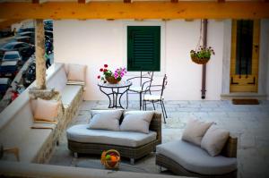 a patio with two couches and a table and a table at Villa Ragusa Vecchia in Dubrovnik