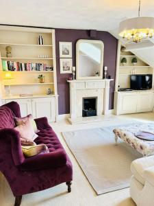 a living room with a couch and a mirror at Ilkley Central Penthouse in Ilkley