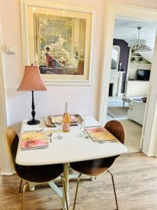 a white table with chairs and a lamp on it at Ilkley Central Penthouse in Ilkley