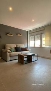 a living room with a couch and a coffee table at Urbanlux Belmonte Suite in Albacete