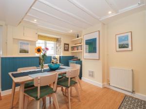 a dining room with a table and chairs at Holly Cottage in Yeovil