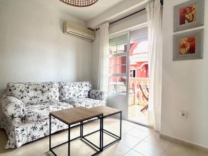 a living room with a couch and a table at Hispalis Mazagón Beach 303 in Mazagón