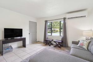 a living room with a couch and a flat screen tv at Florida Vacation Rental about 6 Mi to Downtown Orlando in Orlando