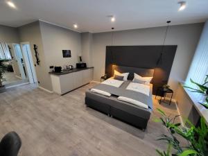 a bedroom with a large bed with a black headboard at Liro Hotel Viersen in Viersen
