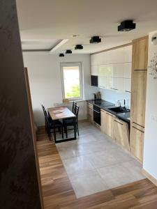 a kitchen with a table and a dining room at Apartament Tarnów Klimeckiego 11 in Tarnów